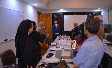 Ahmed Aleyawi, Director General of the House of Manuscripts, inspects the training workshop for manuscript protection